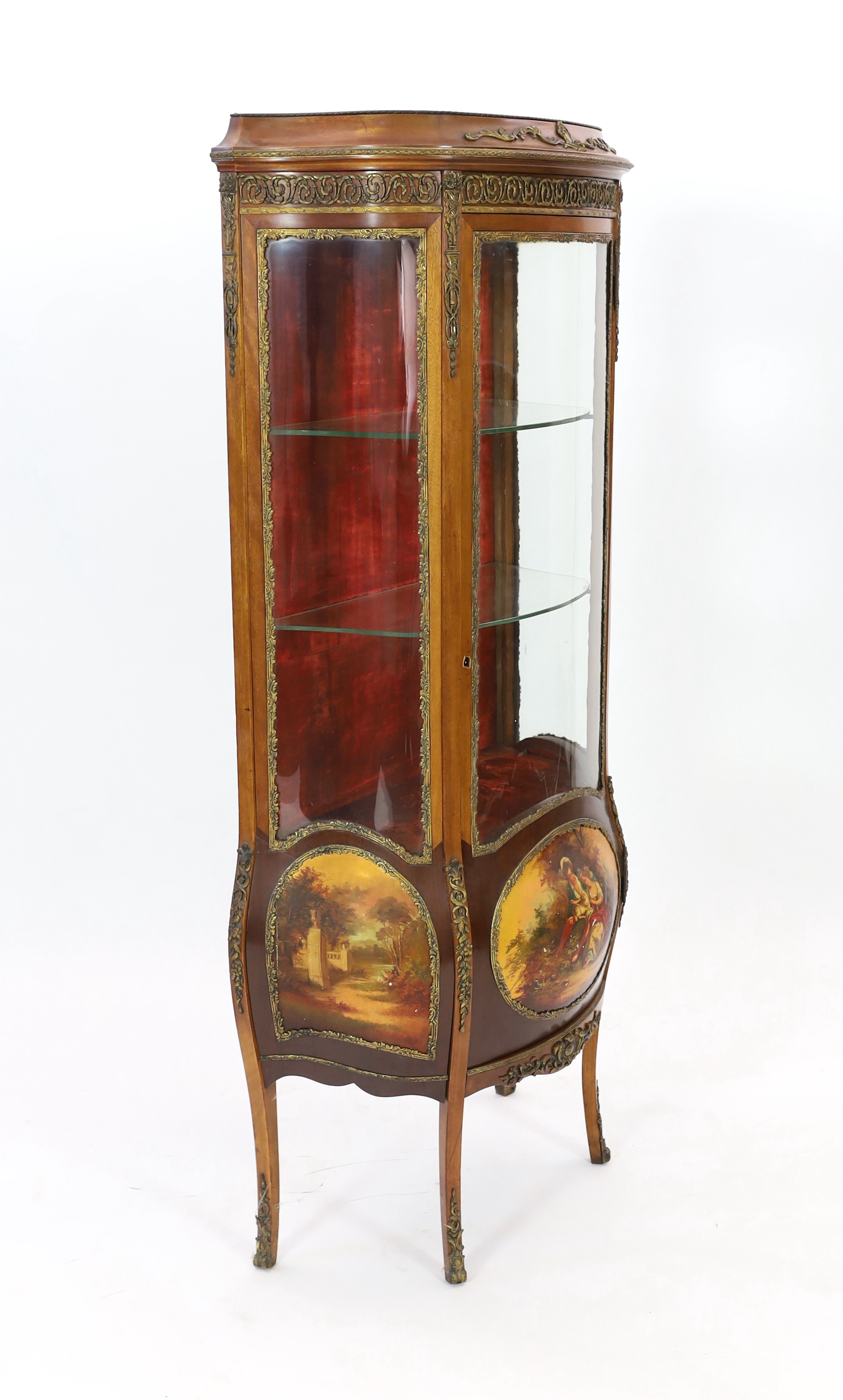 A French Vernis Martin style walnut vitrine, of bombé form with ormolu mounts, three quarter glazed door, lower panels, painted with scenes after Boucher and signed 'Albertine', on cabriole legs, 78cm wide, 42cm deep, 17